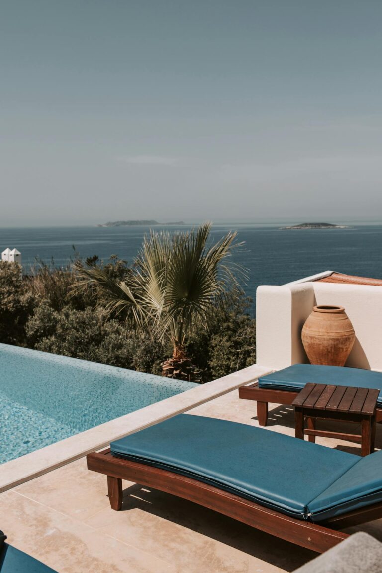 Relax by the luxurious oceanfront pool in a scenic Antalya resort, perfect for summer getaways.